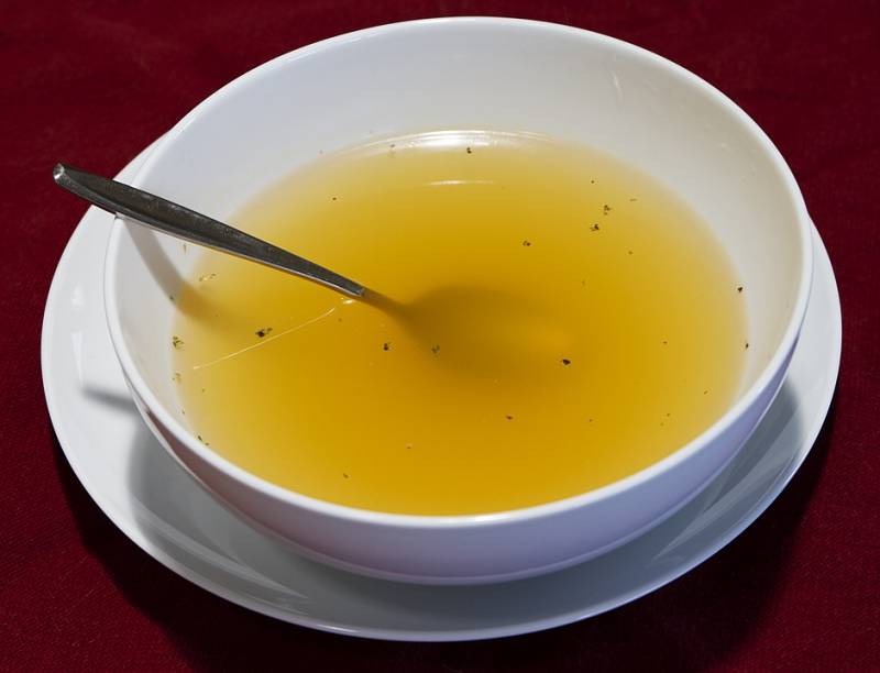 Make your child feel better with chicken broth soup in white bowl