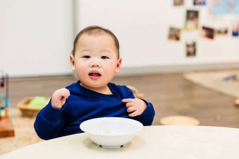 Child at Petit Early Learning Journey eats a nutritional meal to avoid getting sick.