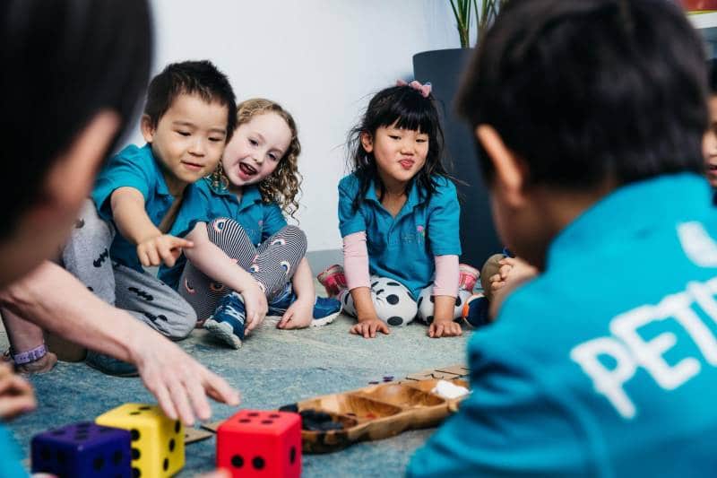 Preschoolers and Kindergarten children play games to develop school readiness skills.