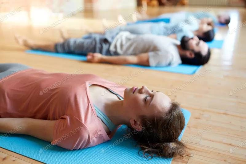 Yoga class ends with Savasana using yoga mats