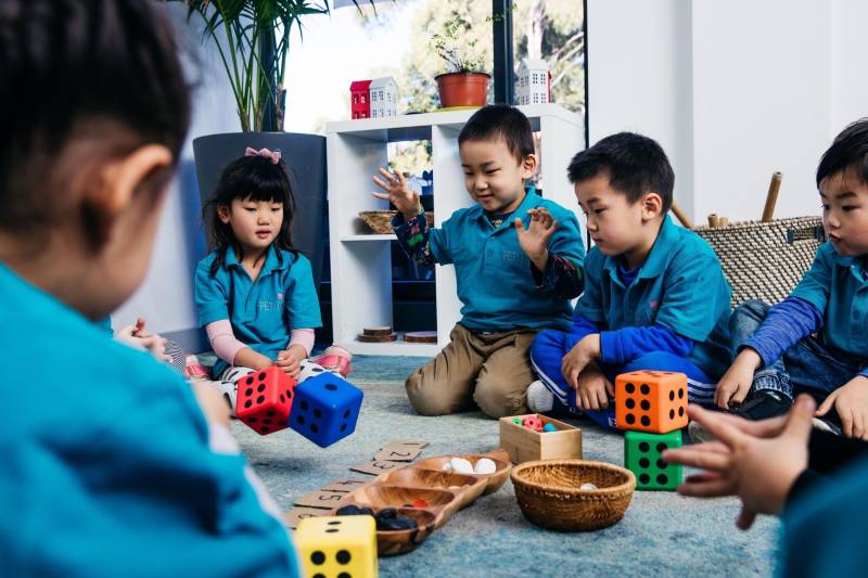 Preschoolers learn numbers with the help of dice ahead of school enrolments.