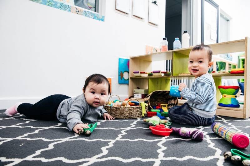Baby looks up from tummy time an activity to encourage gross motor skill development.